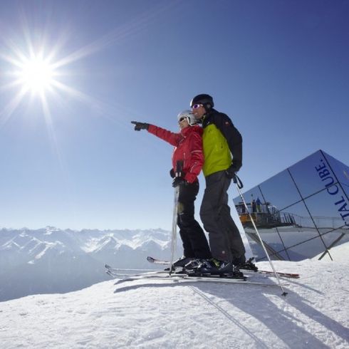 Skifahrer in der Mittagssonne vor Crystal Cube